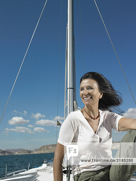 Mature woman relaxing on yacht  smiling