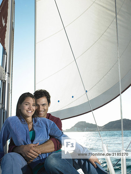Young couple relaxing on yacht  smiling  portrait