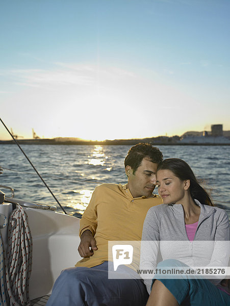 Young couple on yacht  sitting  portrait