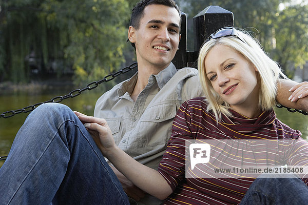 Couple on a dock smiling and relaxing.