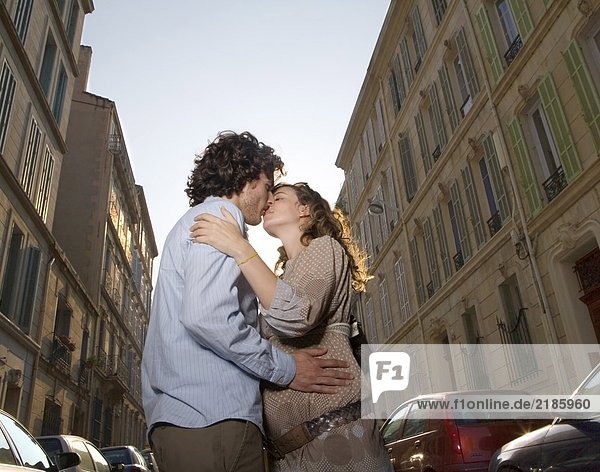 Young couple kissing in street
