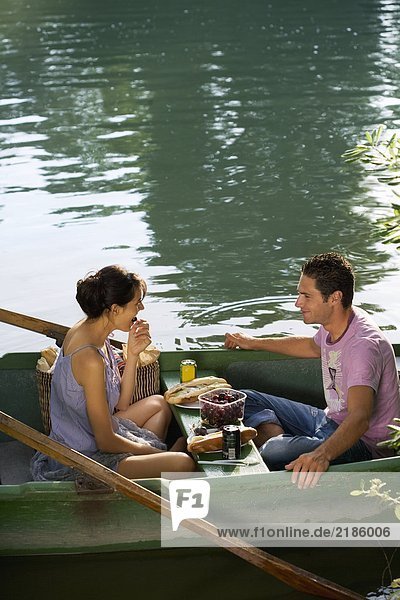Mann und Frau beim Picknick auf dem Boot