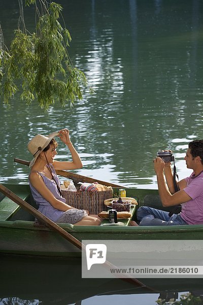Man filming a woman on boat