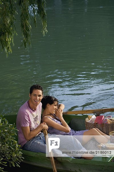 Man and woman in a boat relaxing