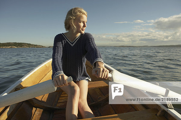 Young woman in rowing boat.