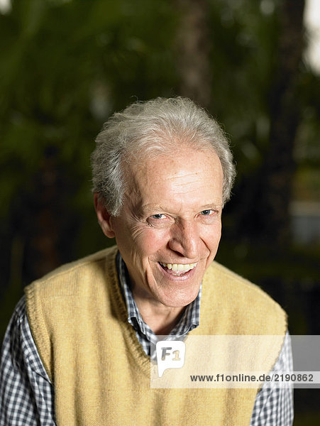Senior man in garden  smiling  portrait