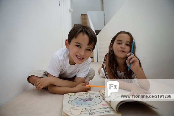 Portrait of a girl and boy coloring.