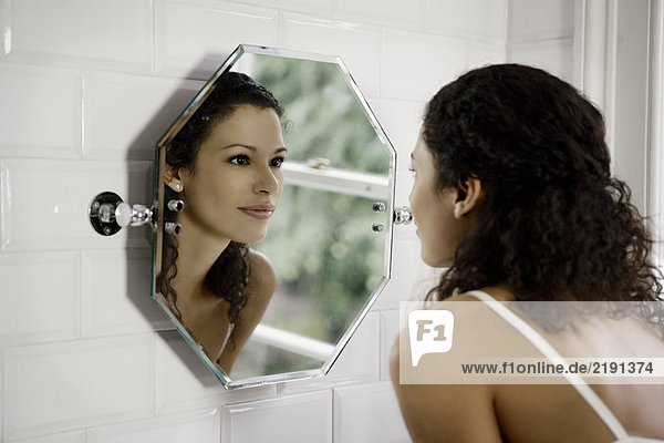 Woman looking in mirror.