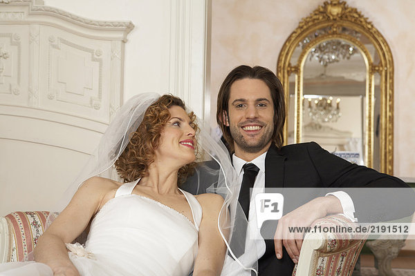 young bridal couple sitting together  portrait of young man
