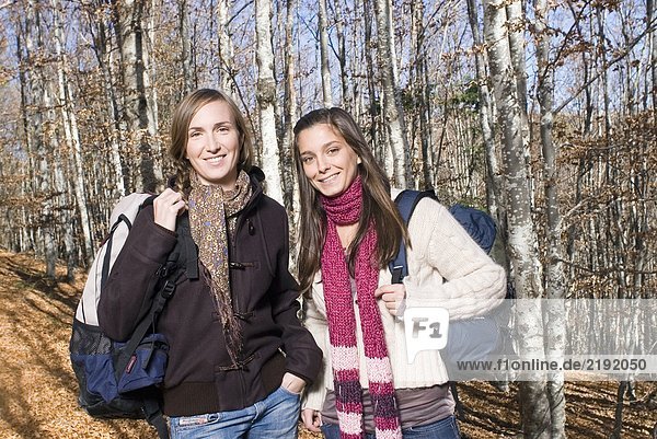 Portrait of 2 young women in the woods.