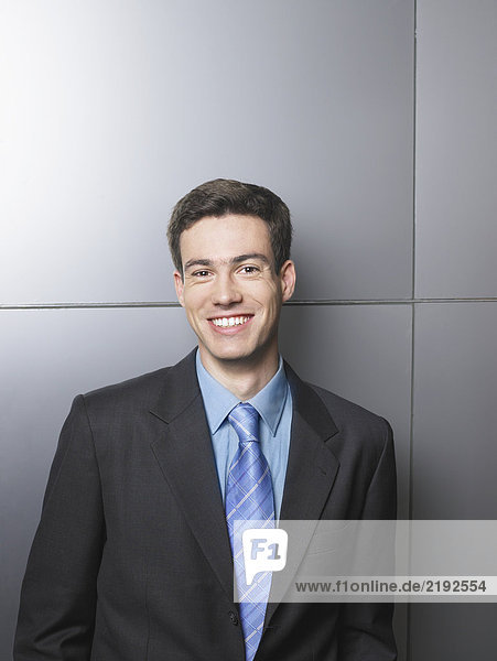 Businessman standing in front of a white wall