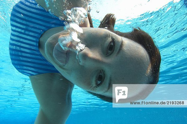 Female swimmer pulling face  portrait  underwater view