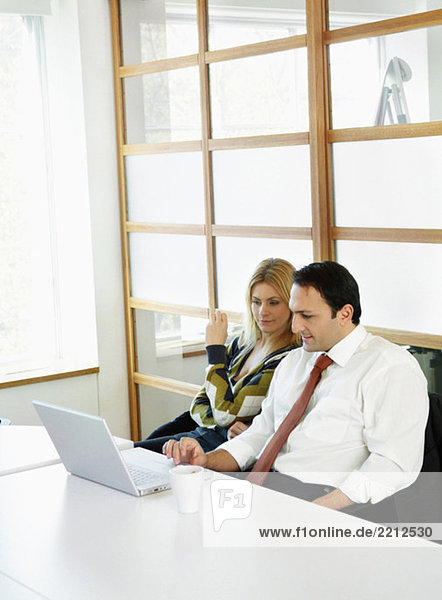 Man and woman in front of computer