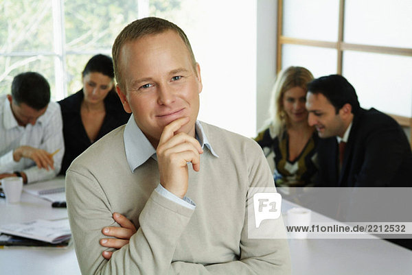 Businessman in front of colleagues