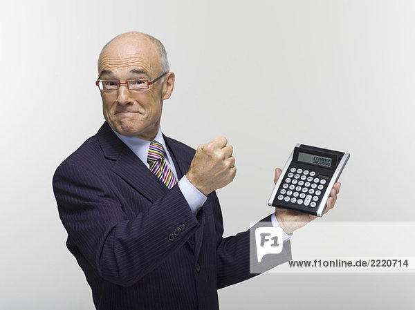 Businessman holding calculator  portrait