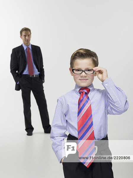 Father and son (8-9) in business clothing  portrait