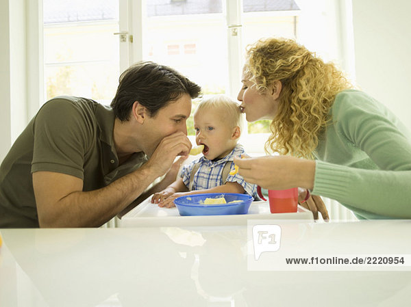 Young family  father feeding baby boy  (12-24 months)