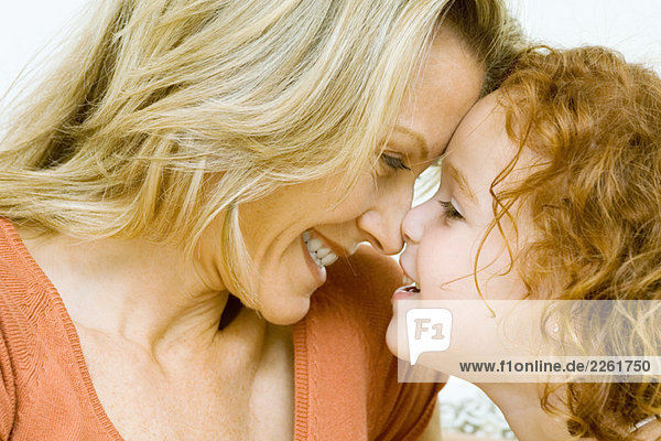 Mutter und Tochter berühren Nasen und lächeln sich an  Ausschnittansicht