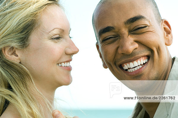 Couple laughing together  man looking at camera  close-up