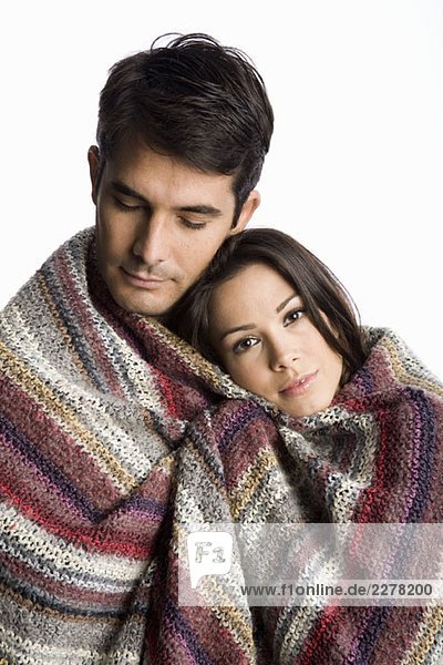 A couple wrapped in a blanket