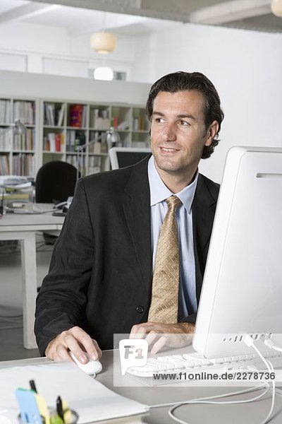 A businessman using a computer in an office