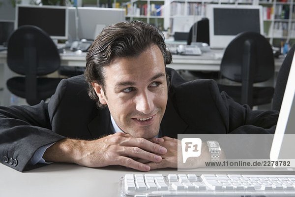 A businessman resting on his desk