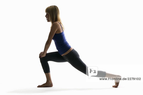 Studio shot of a woman in a lunge pose