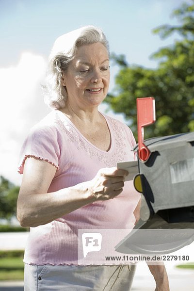 A senior woman checking the mailbox