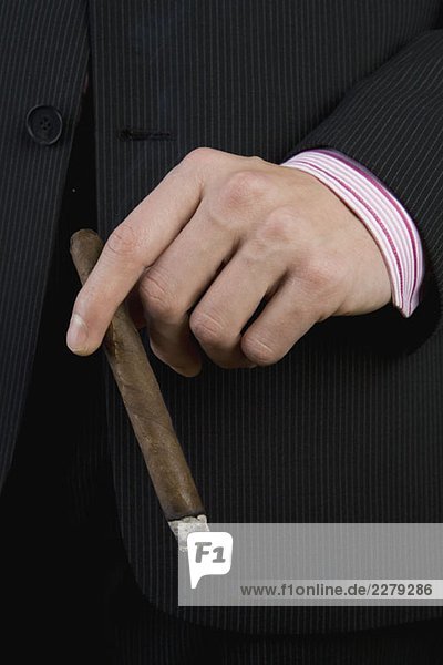A businessman holding a cigar