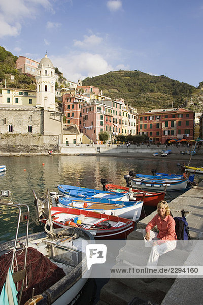 Italy  Liguria  Vernazza  Woman sitting on landing stage