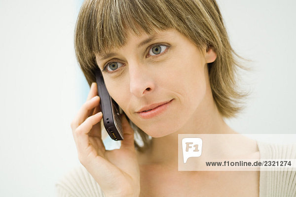 Woman using cell phone  looking away  close-up