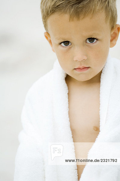 Little boy wrapped in towel  looking at camera  portrait