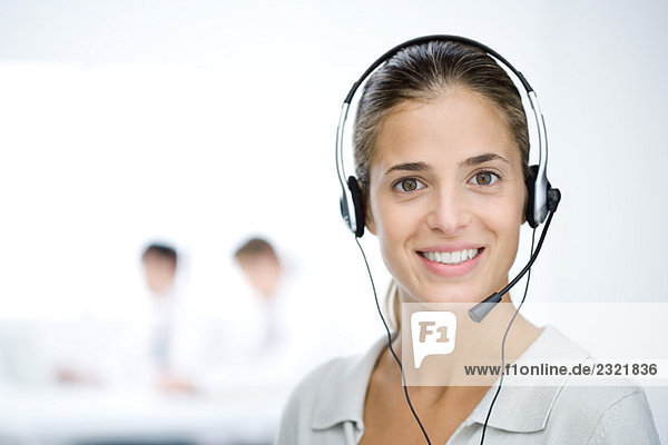 Customer service representative with headset  smiling at camera  portrait