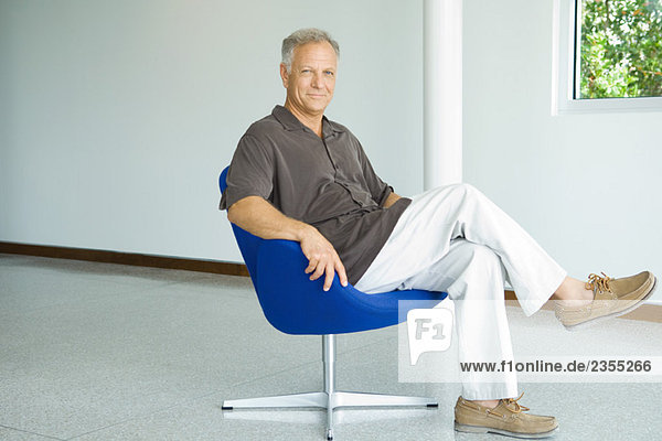 Mature man sitting in chair  full length  portrait