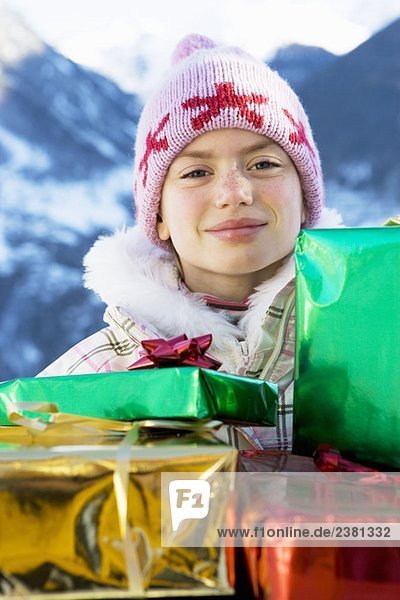 Porträt eines Mädchens mit Geschenken im Schnee