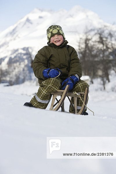 Boy on sitting sledge