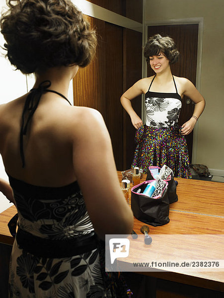 Female trying out clothes by the mirror