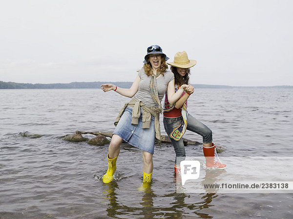 Two women standing in shallow water
