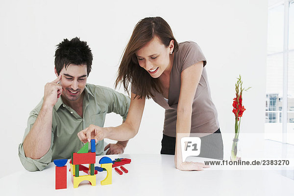 Man and woman happily build model house