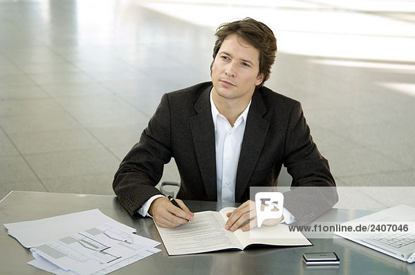 Businessman sitting at a desk and thinking