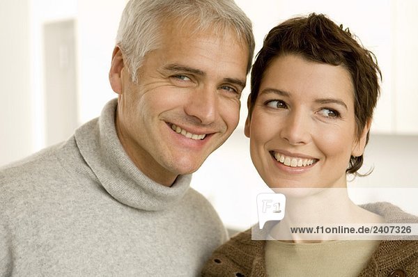 Close-up of a mature man and a mid adult woman smiling