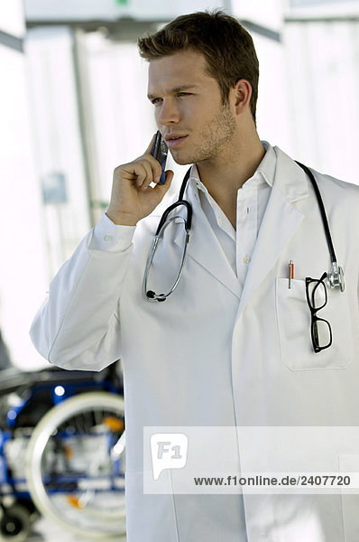 Male doctor talking on a mobile phone