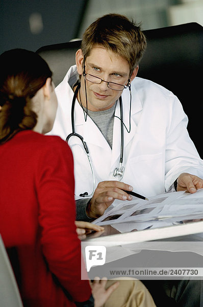 Male doctor explaining a medical record to a female patient