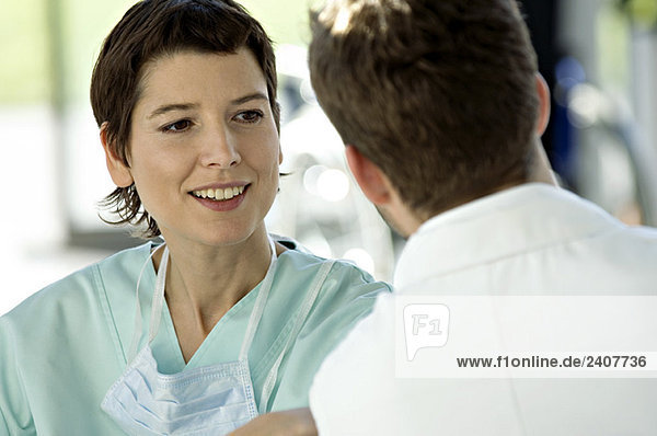 Close-up of a female doctor discussing with a male doctor