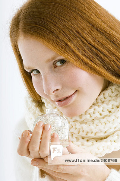 Portrait of a young woman smelling perfume