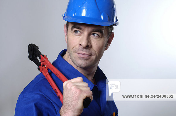 Close-up of man holding pliers