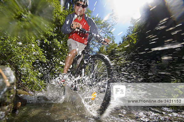 Mountainbiker crossing a creek