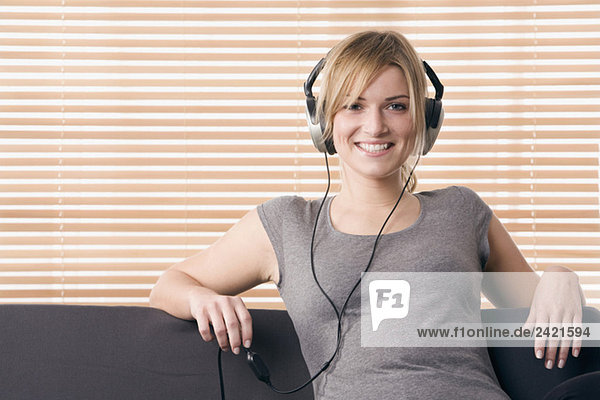 Blonde woman relaxing  smiling  with headphones  portrait