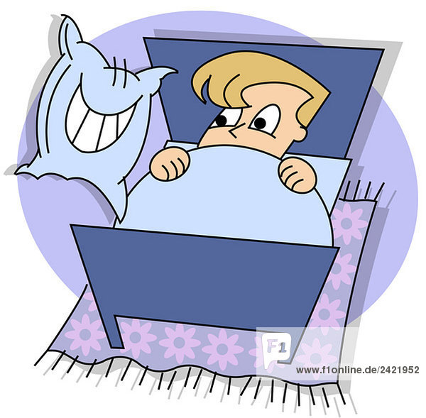Boy lying in bed  facing grinning pillow