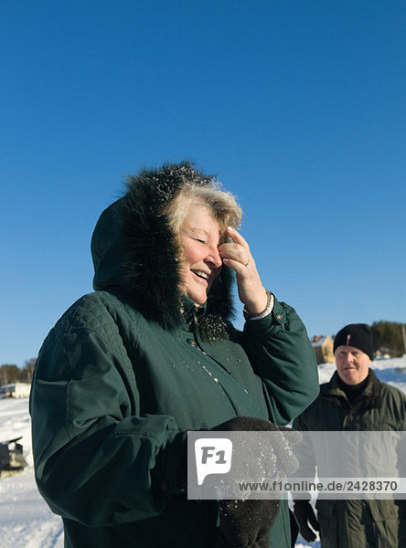 Woman wipes snow from her eyes